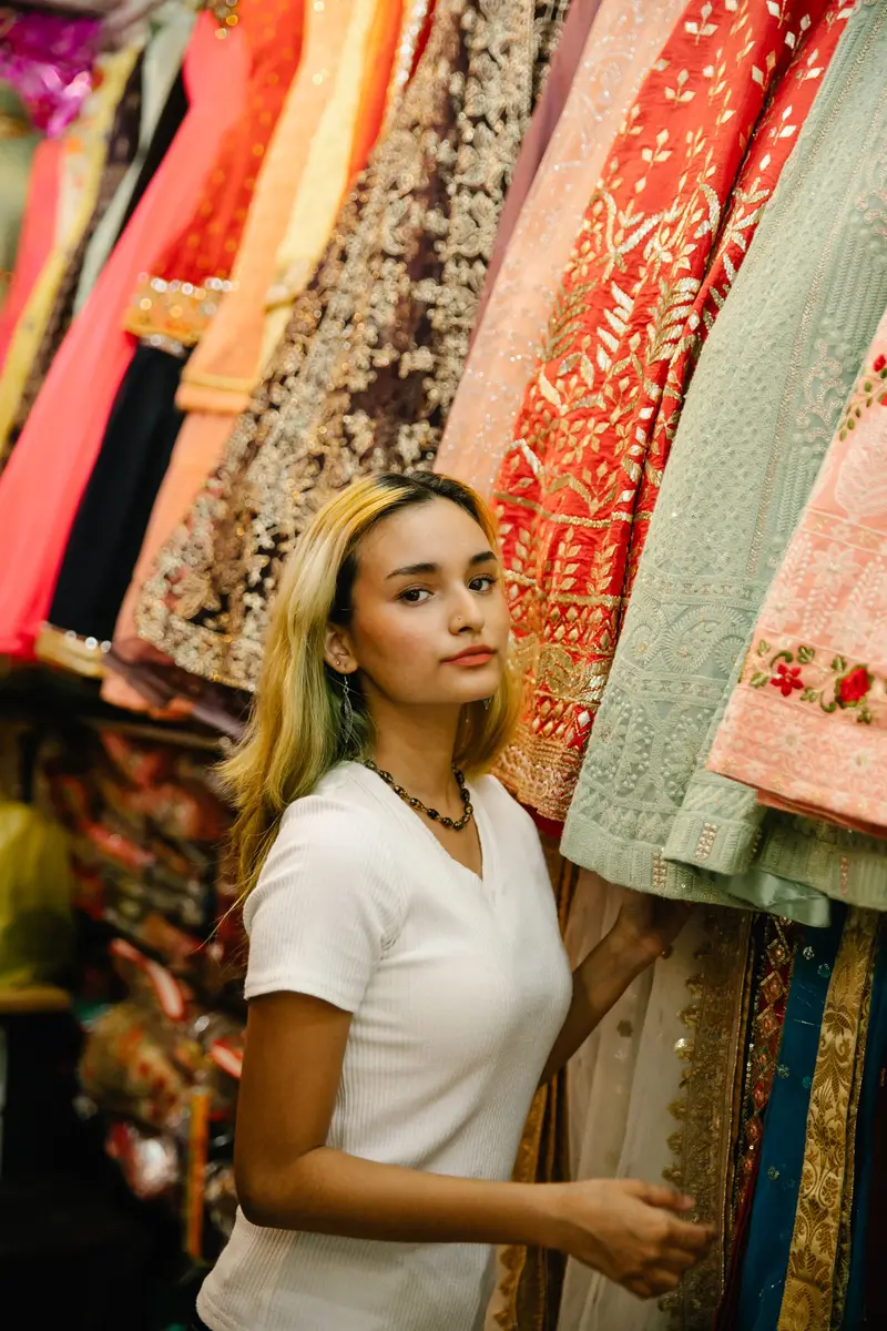 A customer choosing fabric in a clothing shop