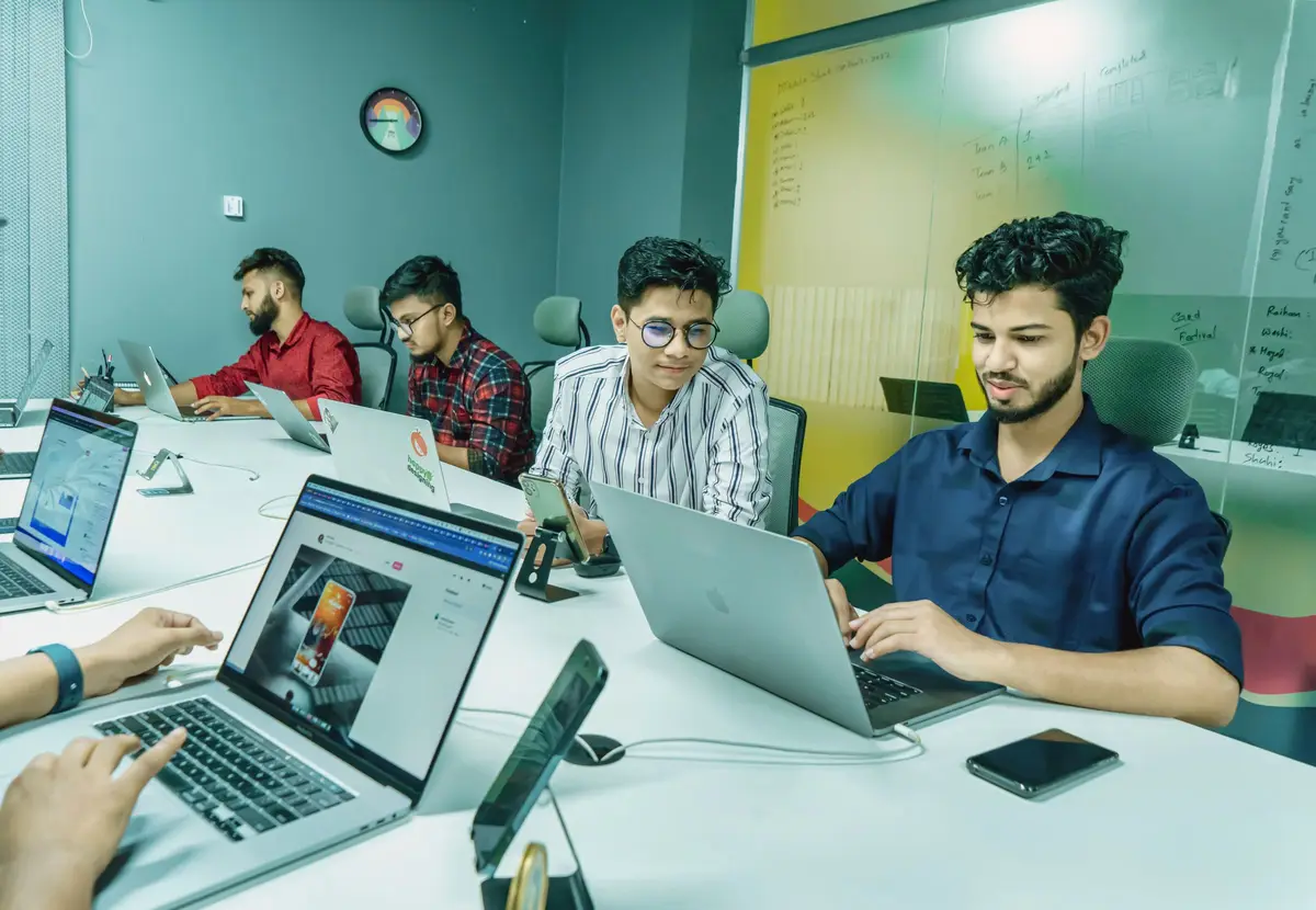 A product team working together at laptops